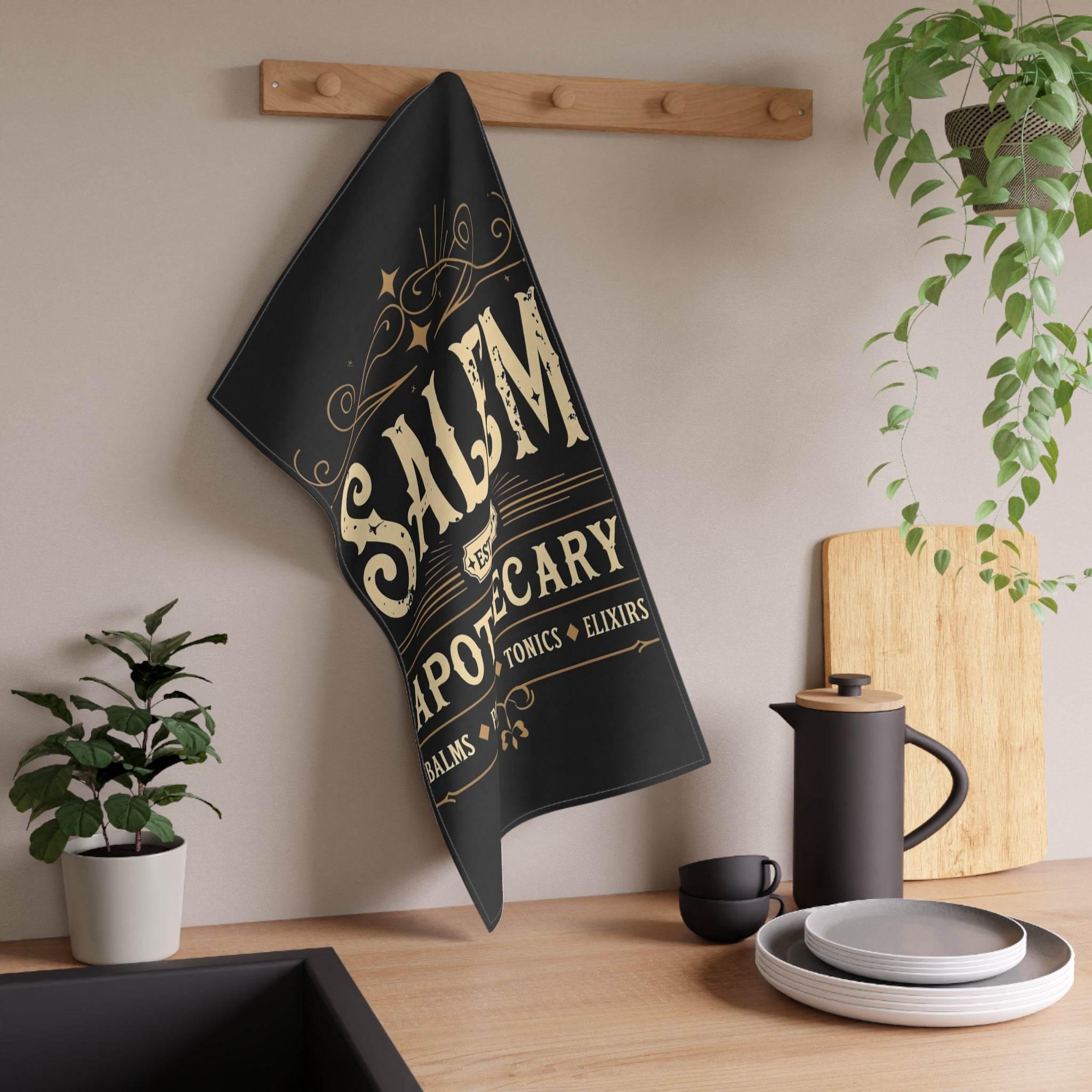Printify eco-friendly kitchen towel black with vintage apothecary gold print hanging in modern kitchen