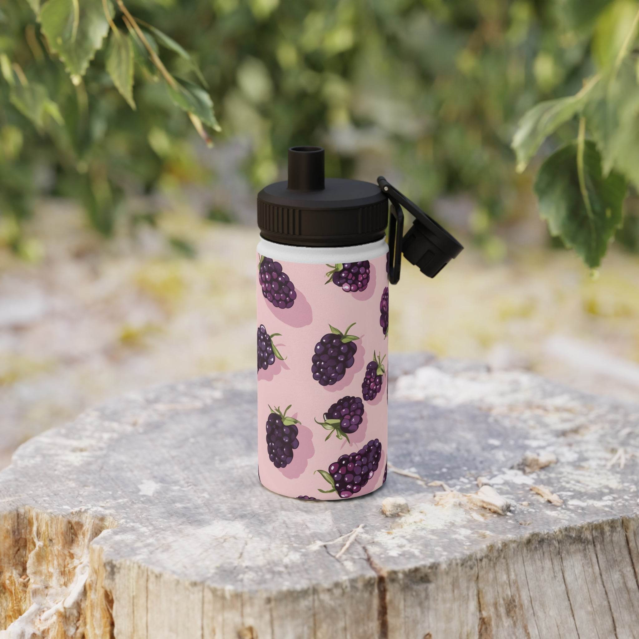 Printify stainless steel eco water bottle with blackberries design and black flip lid on tree stump