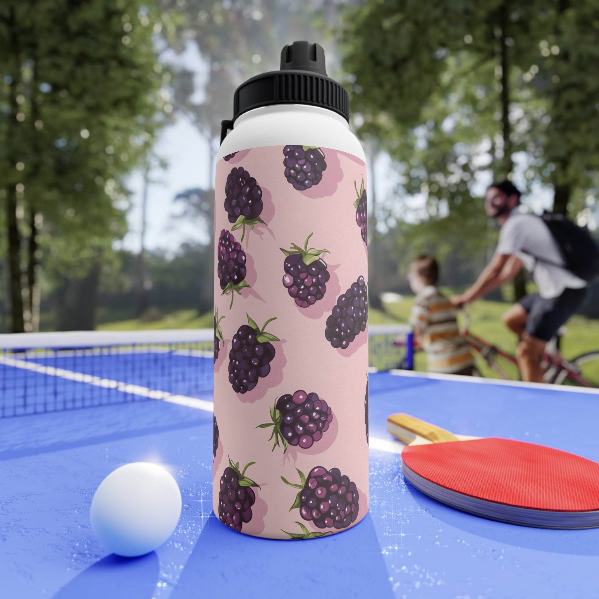 Printify stainless steel eco water bottle with blackberry design on a blue ping pong table outdoors