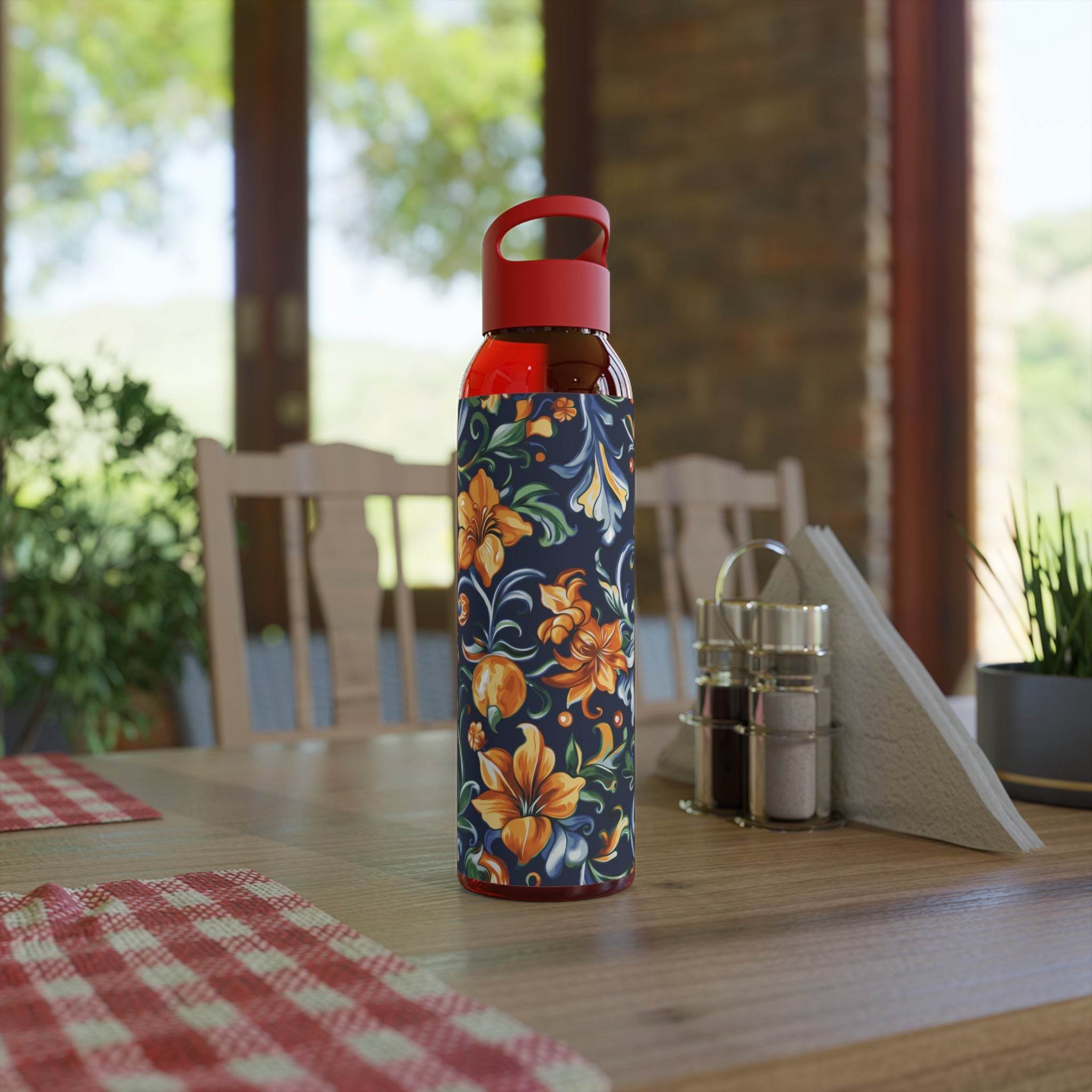 Printify stylish eco water bottle with floral design and red cap placed on wooden kitchen table