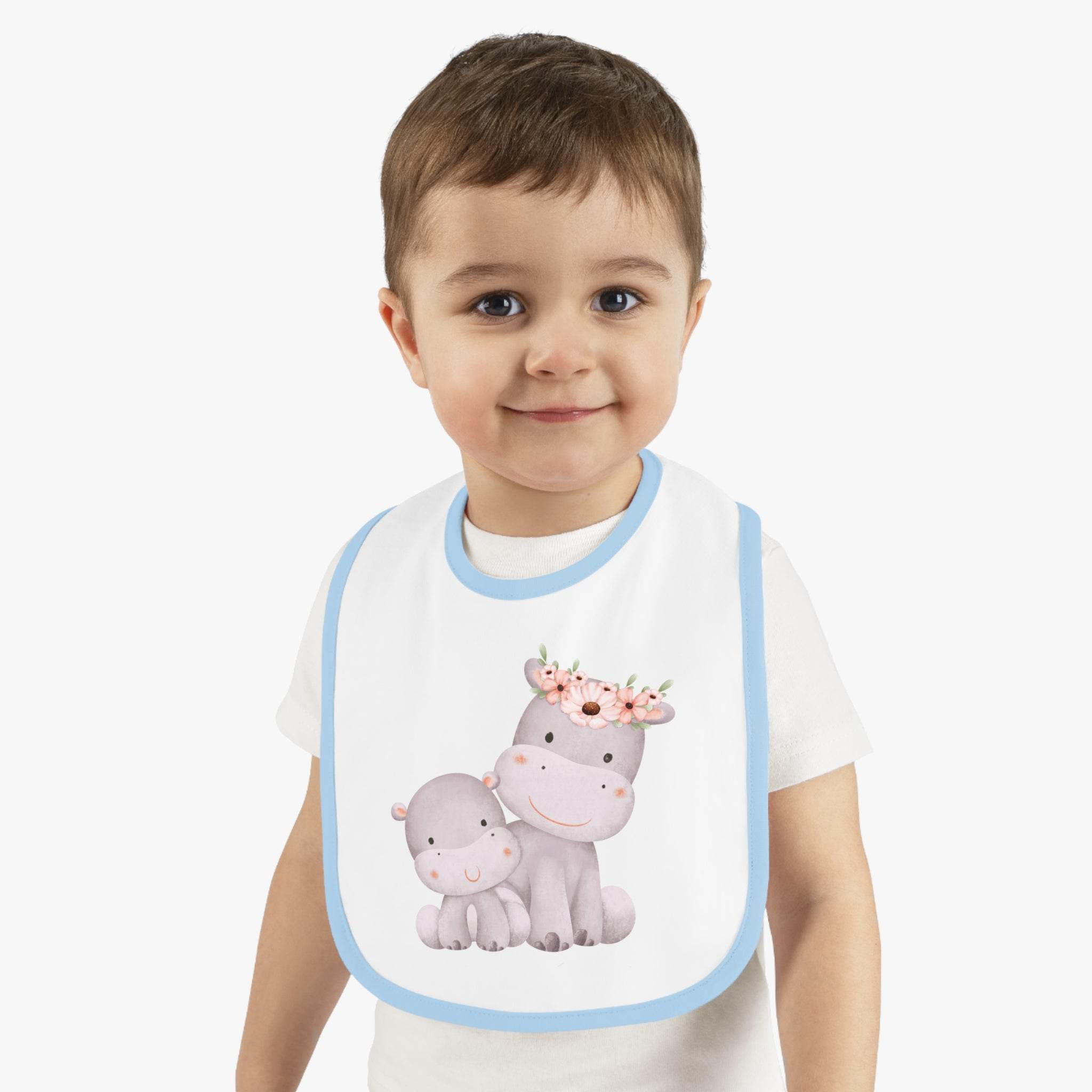 Toddler wearing sustainable baby jersey bib with blue trim and cute hippo design by Printify