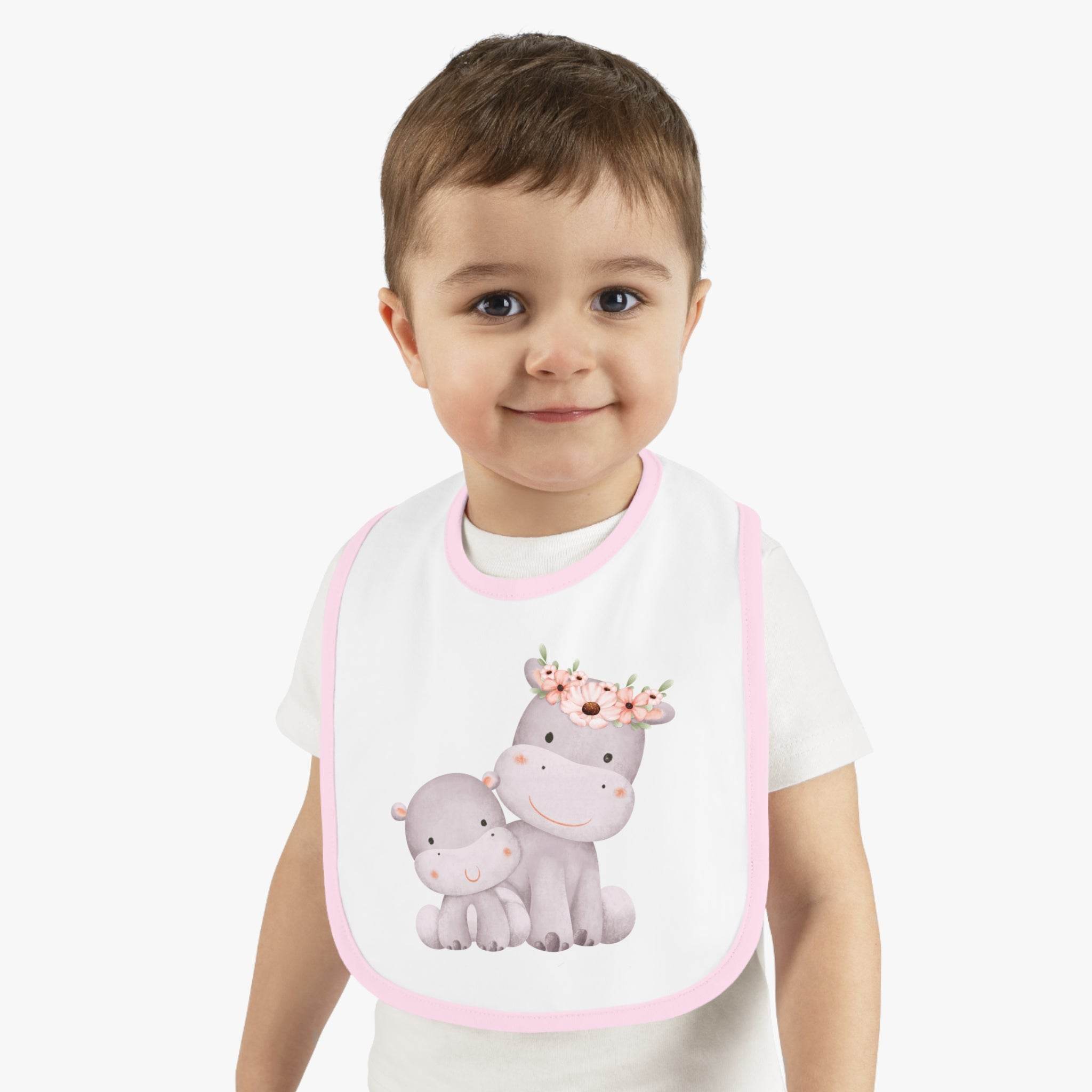Printify sustainable baby jersey bib with pink trim and cute hippo design worn by toddler