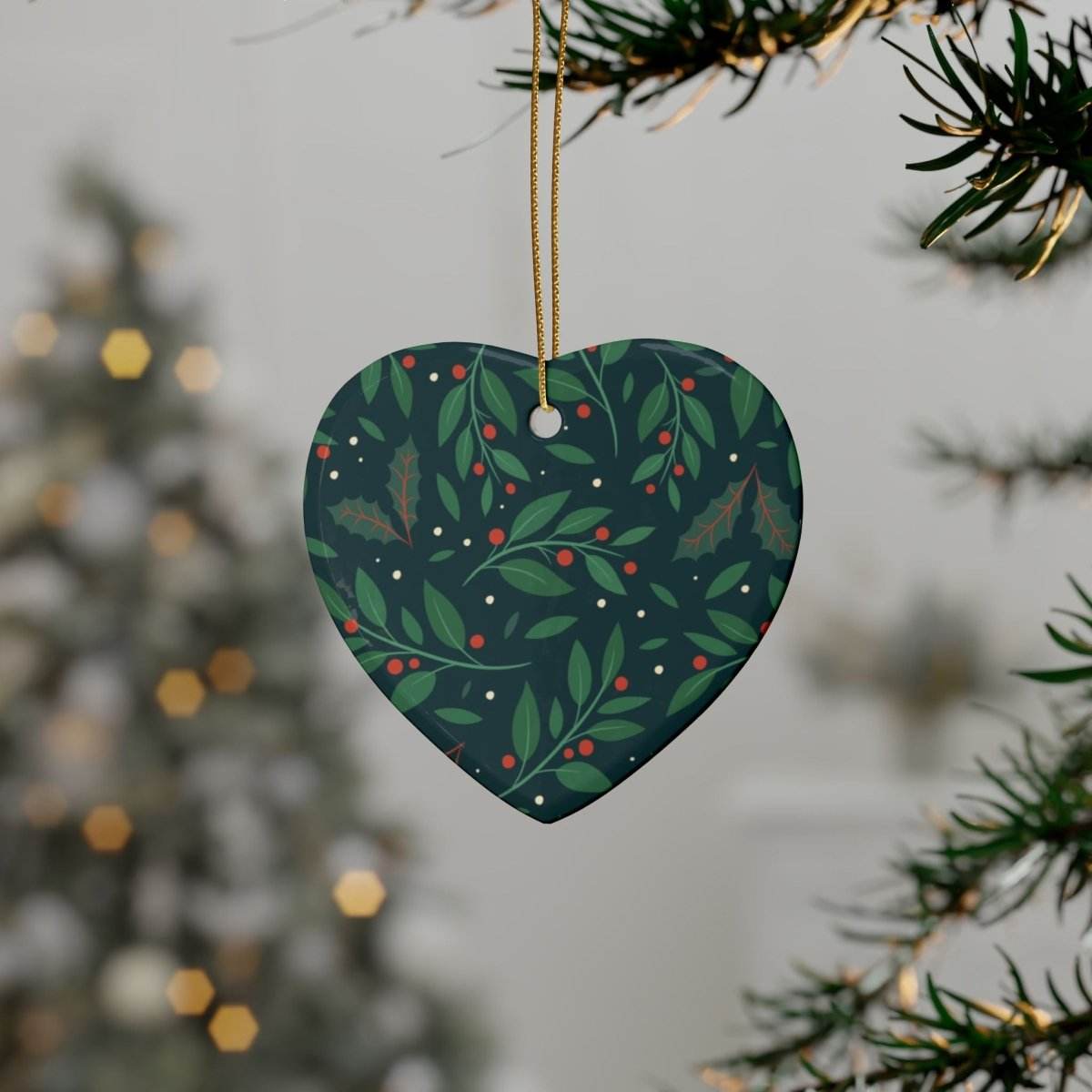 Heart-shaped sustainable ceramic holiday decorations with green leaves and red berries hanging on Christmas tree