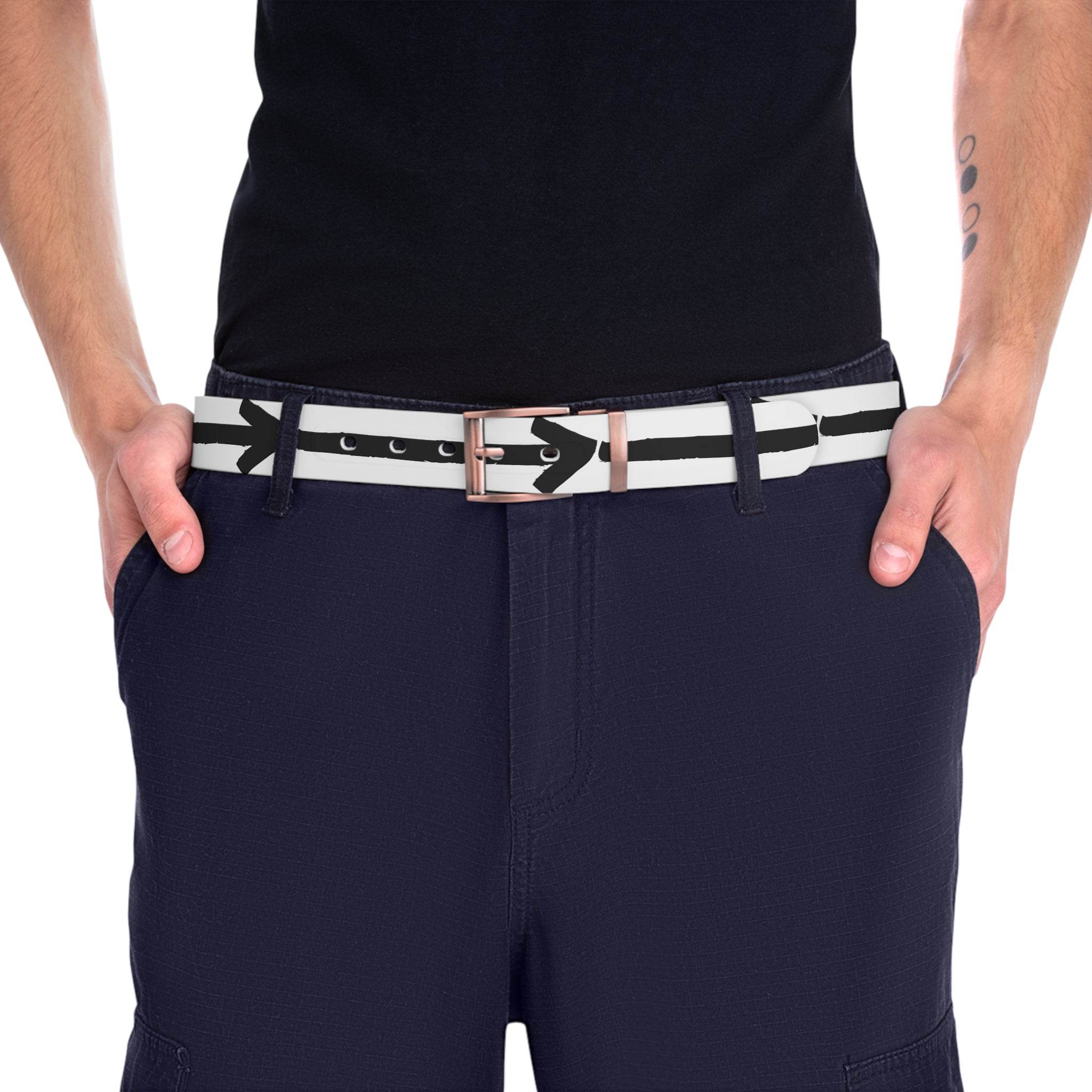 Person wearing a white and black striped sustainable direction belt with arrow design and silver buckle