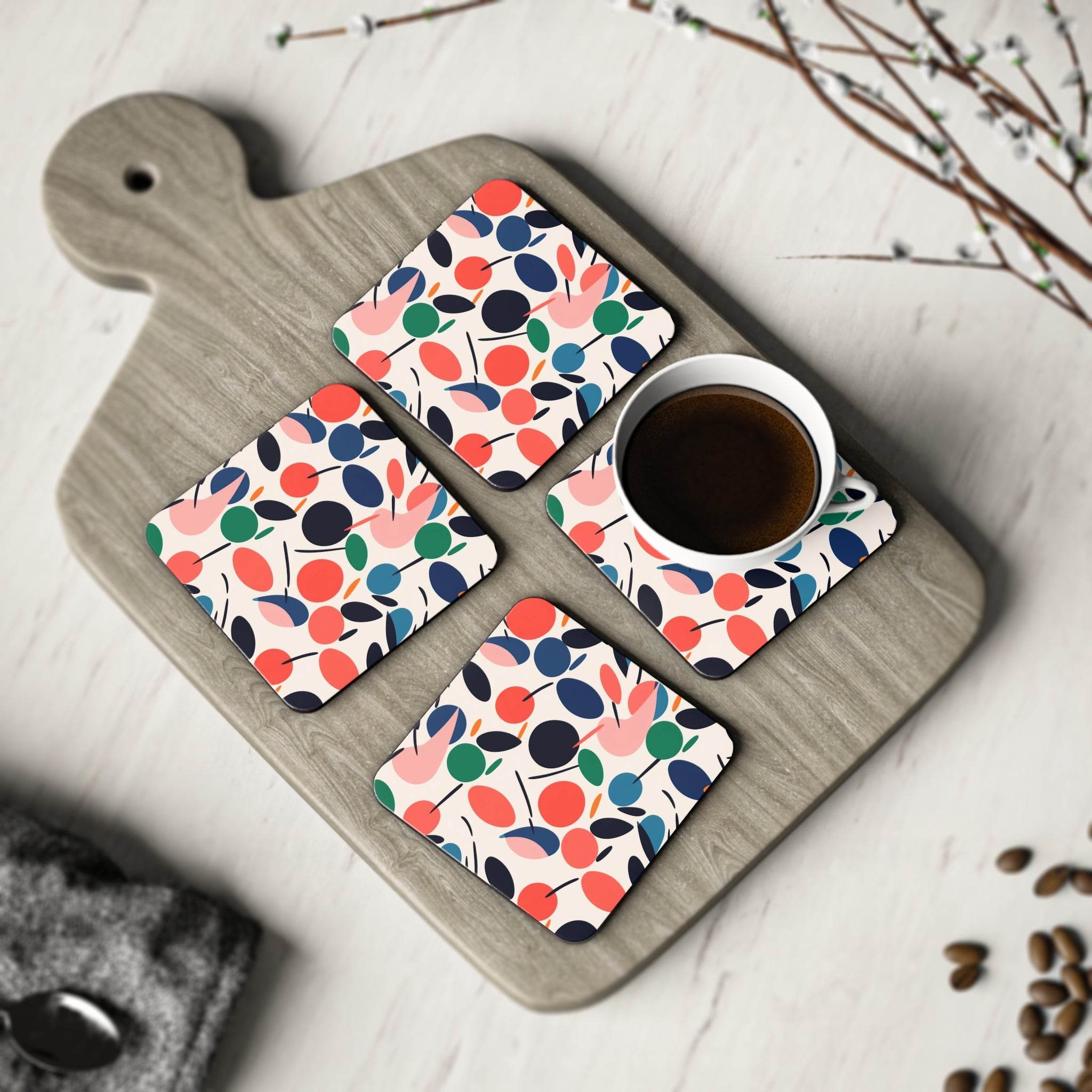 Printify kitchen accessories featuring colorful sustainable drink coasters with a cherry pattern on a wooden board