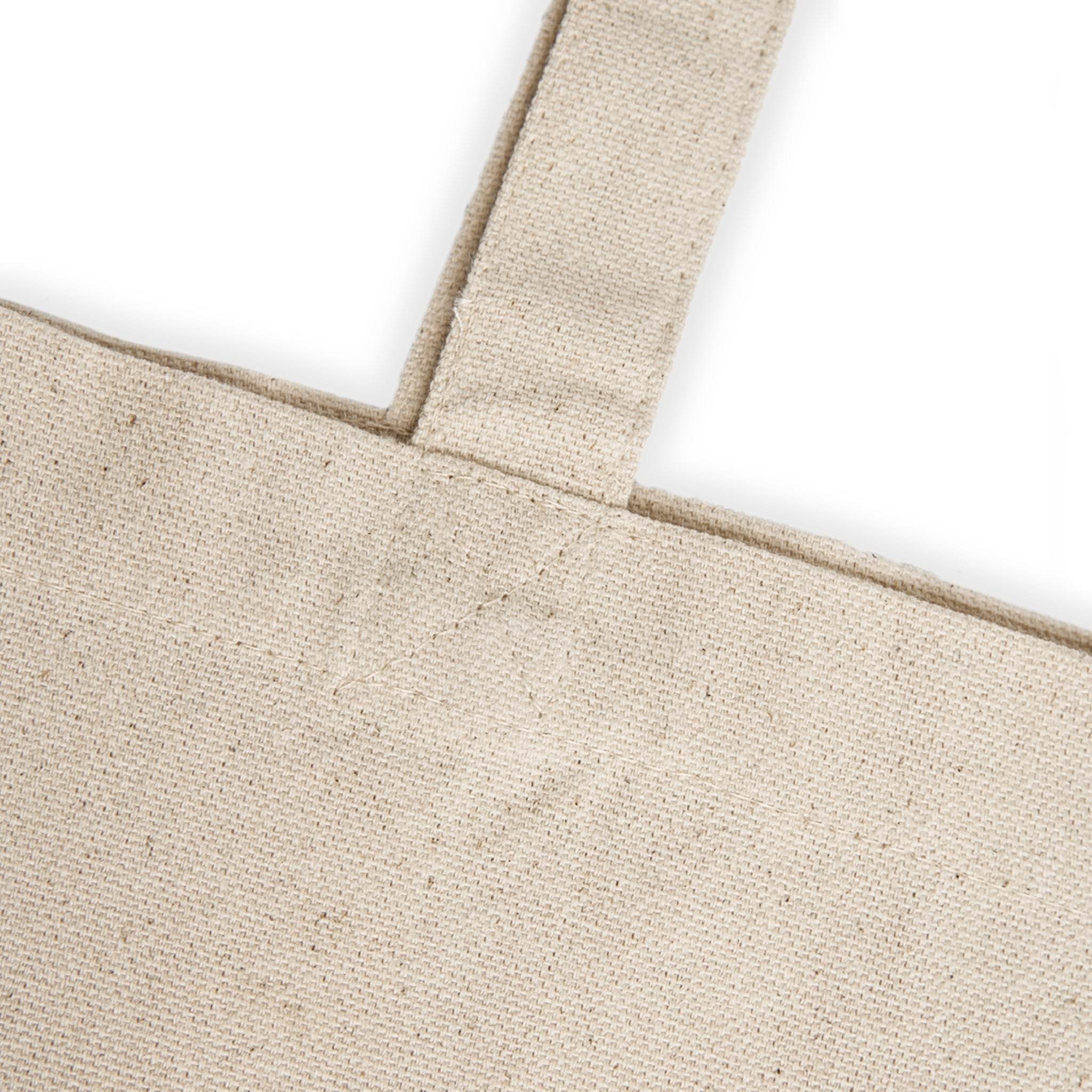 Close-up of natural fabric teacher canvas tote bag strap and stitching detail from Printify