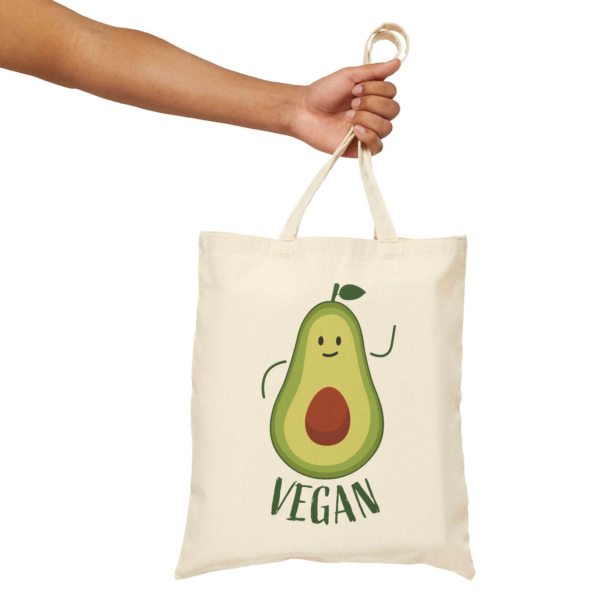 Printify eco-friendly cotton tote bag with cute vegan avocado design held by hand