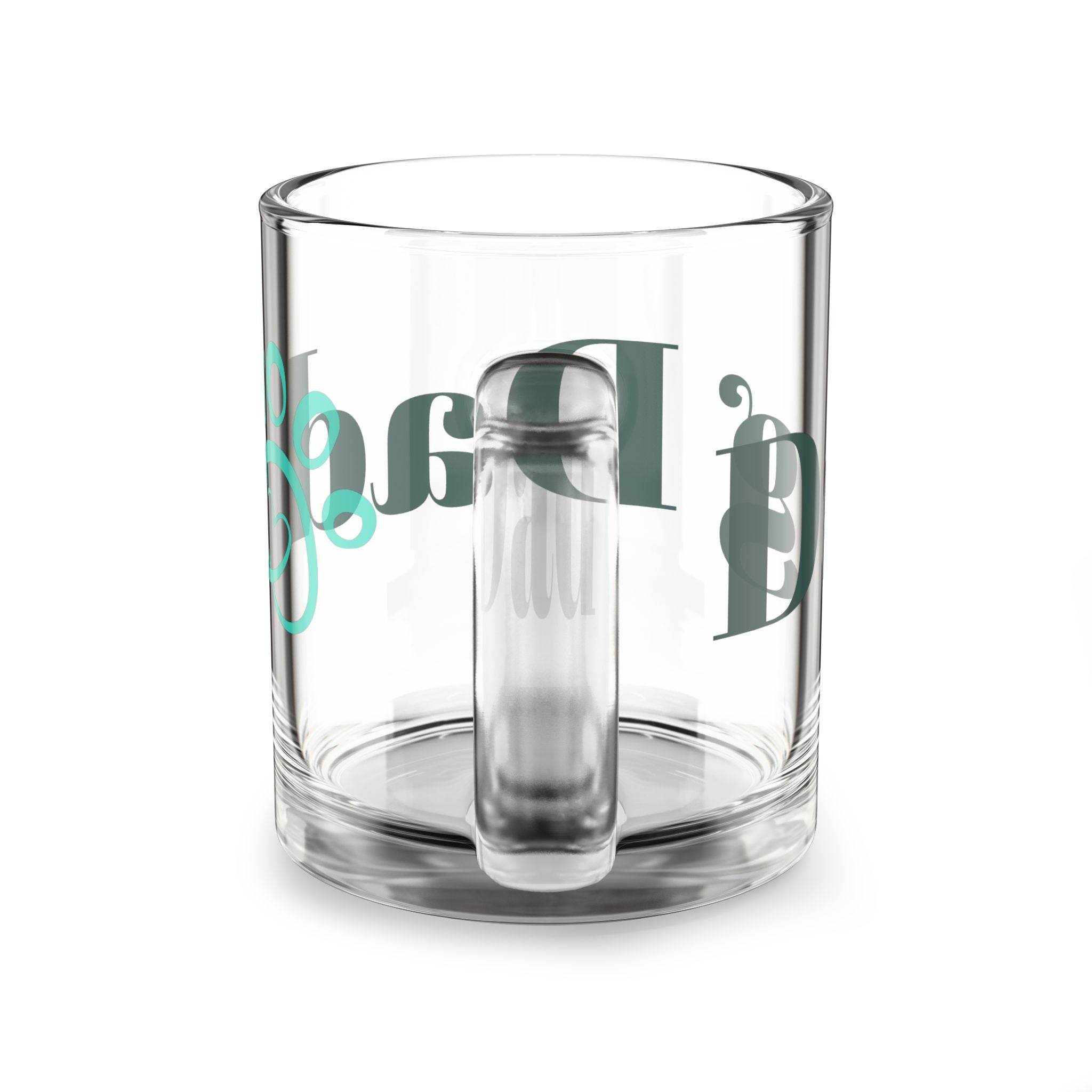 Clear glass mug with a handle featuring eco-friendly dog dad mug text and design by Printify