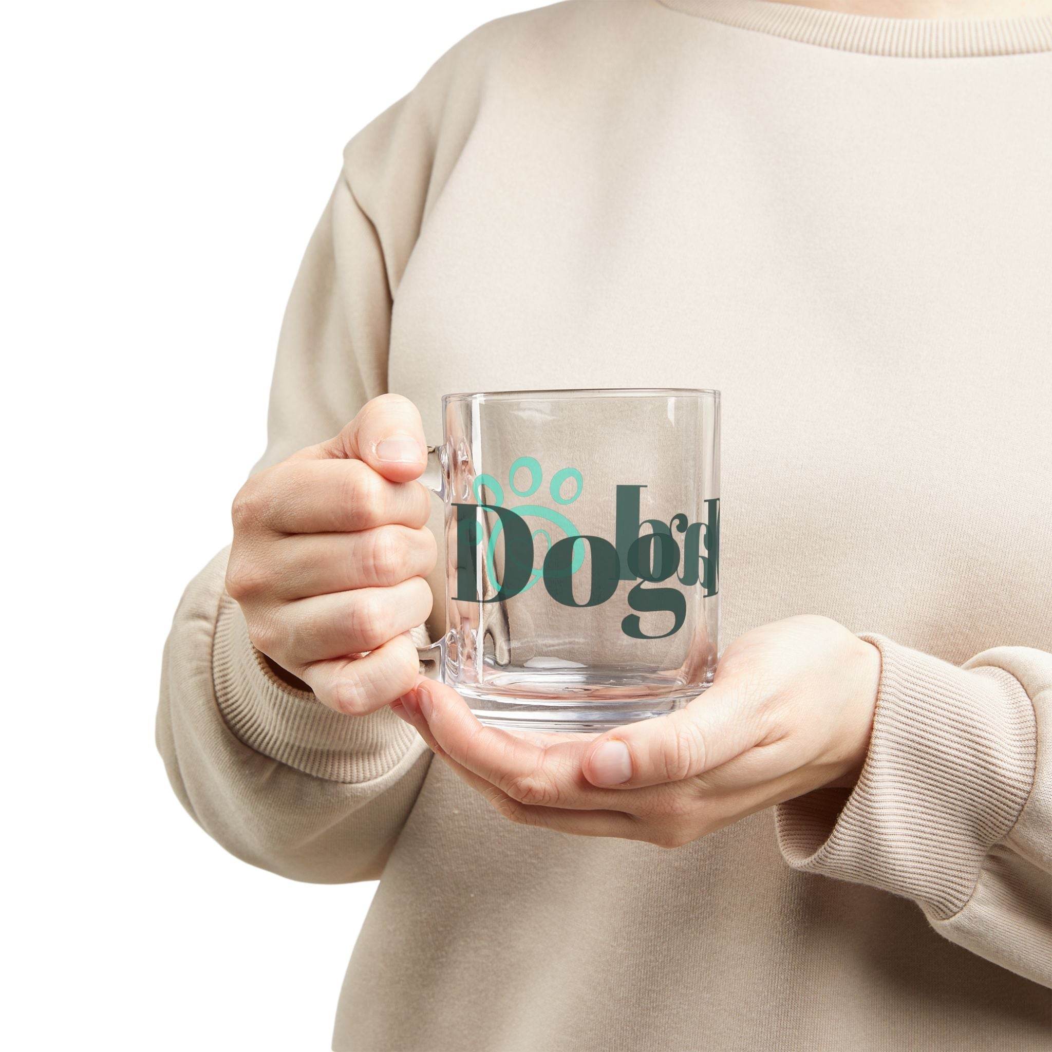 Clear glass eco-friendly dog dad mug with paw print held by person in beige sweatshirt