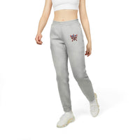 Woman wearing gray eco Adidas pants with colorful logo embroidery and white sneakers