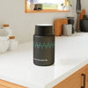 Printify eco-friendly insulated food storage container in black with teal wave design on kitchen countertop