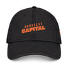 Black eco-friendly denim hat from Printify with orange Barbecue Capital logo on front