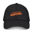 Black eco-friendly denim hat from Printify with orange Barbecue Capital logo on front