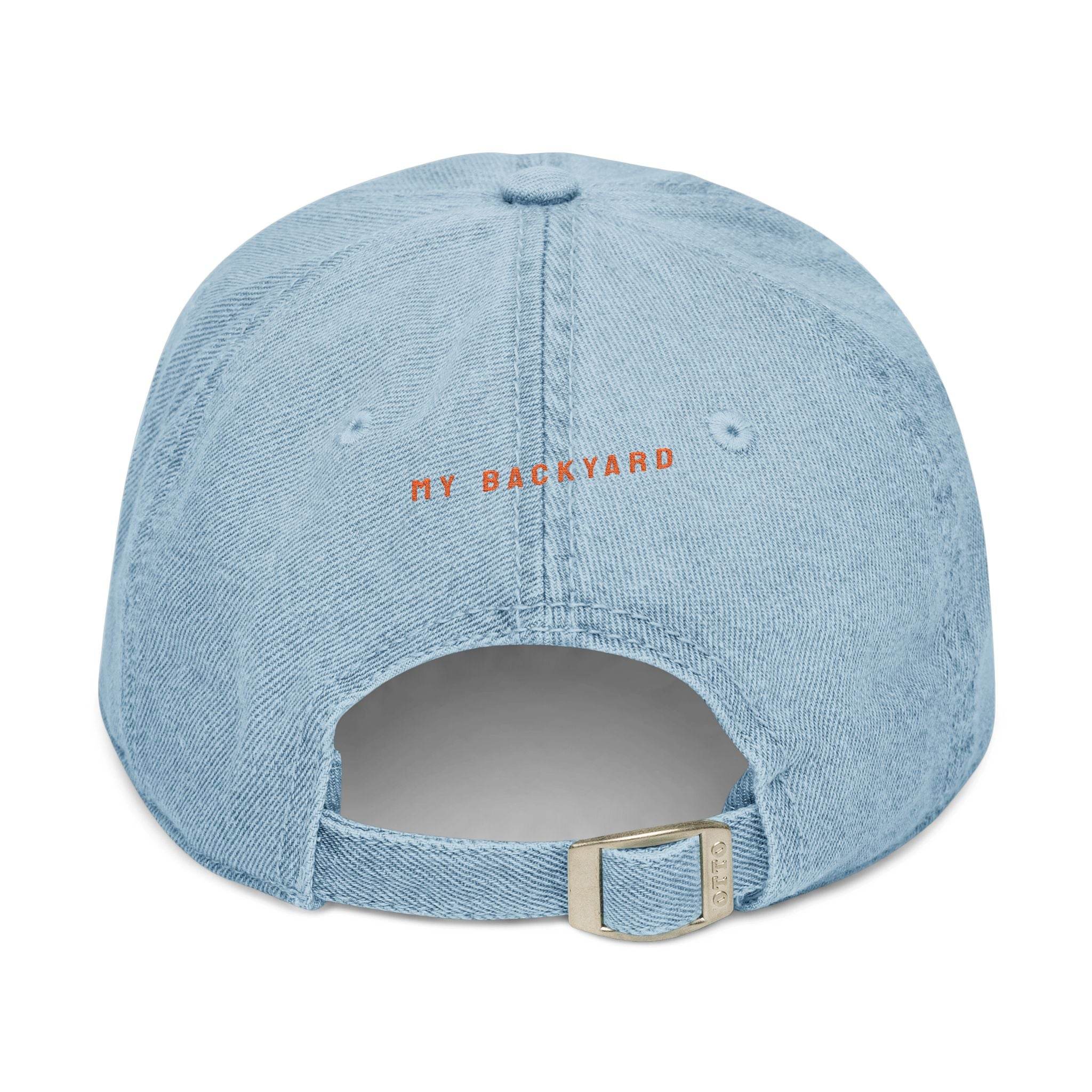 Back view of eco-friendly denim hat by Printify in light blue with adjustable strap and My Backyard text