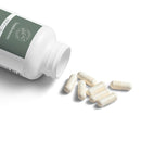 Open bottle of Printify BioFlora probiotic capsules with several white capsules spilled on white surface