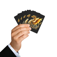 Hand holding fan of dragon design playing cards with golden dragon artwork on black background
