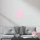 Pink checkered sustainable uncoated posters displayed on wall above gray sofa with plaid blanket in modern living room