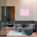 Modern living room with Printify sustainable uncoated posters featuring pink checkered design on wall