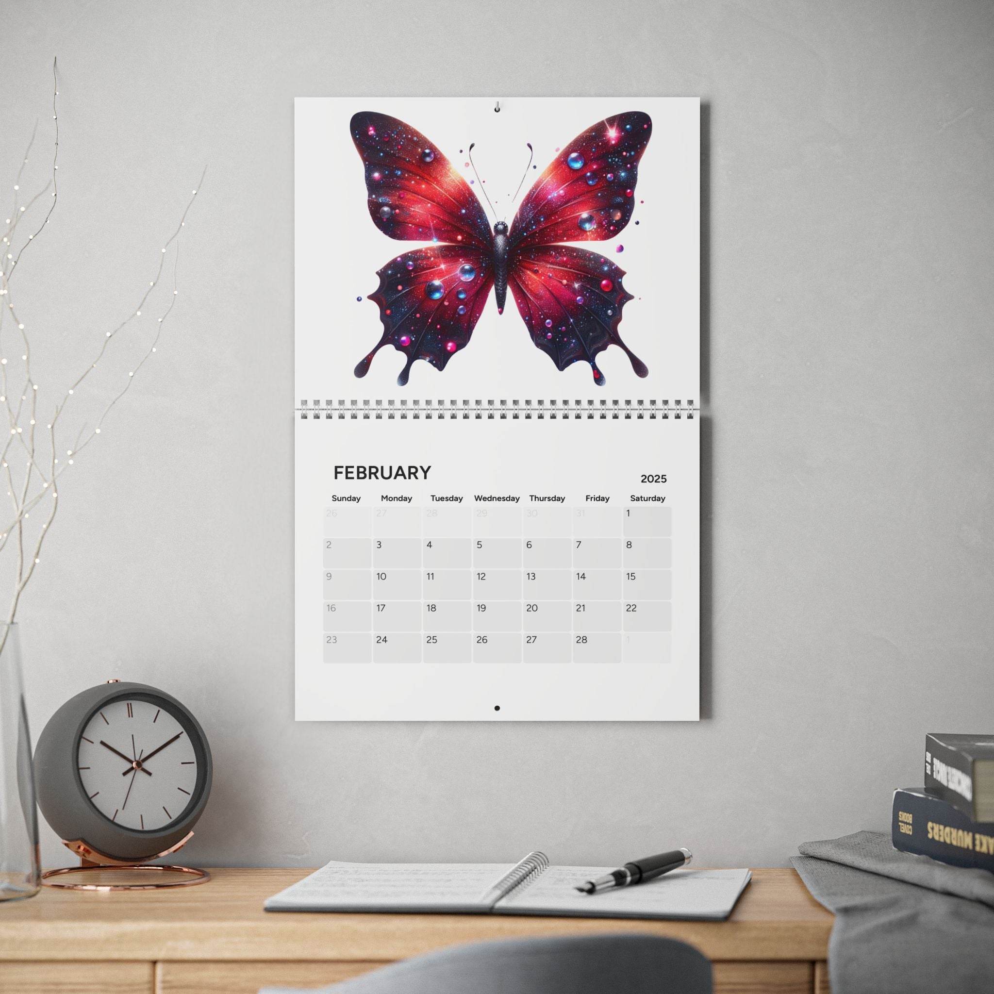 Printify butterfly design 2025 calendar hanging on wall above desk with clock pen and books
