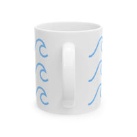 White ceramic mug with wave pattern in blue on both sides and a handle in the center