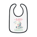 White baby bib with black trim featuring a cute sleeping dinosaur and text baby saurus dinosaur print baby bib