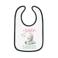 White baby bib with black trim featuring a cute sleeping dinosaur and text baby saurus dinosaur print baby bib