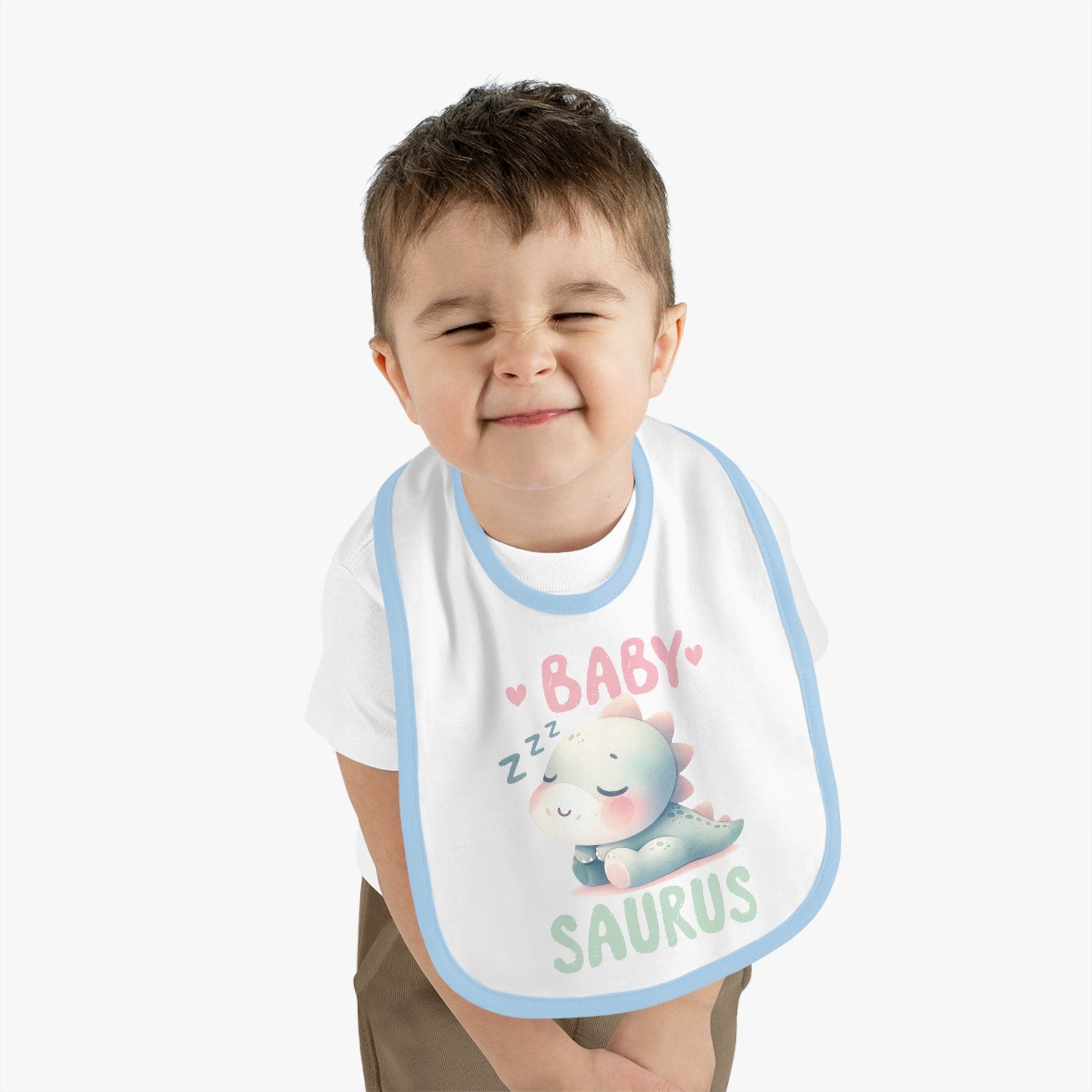 Printify dinosaur print baby bib with cute sleeping dinosaur and pastel colors worn by toddler