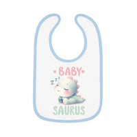 White dinosaur print baby bib with blue trim featuring a sleeping baby dinosaur and text baby saurus