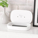 Printify dual function charger sanitizer in white with a smartphone inside on a countertop