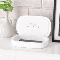 Printify dual function charger sanitizer in white with a smartphone inside on a countertop