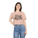 Woman modeling eco-friendly bride squad crop top in blush pink Printify tee with black script logo and short sleeves