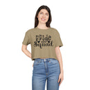 Woman model wearing eco-friendly bride squad crop top khaki with black Bride Squad print paired with high waisted jeans