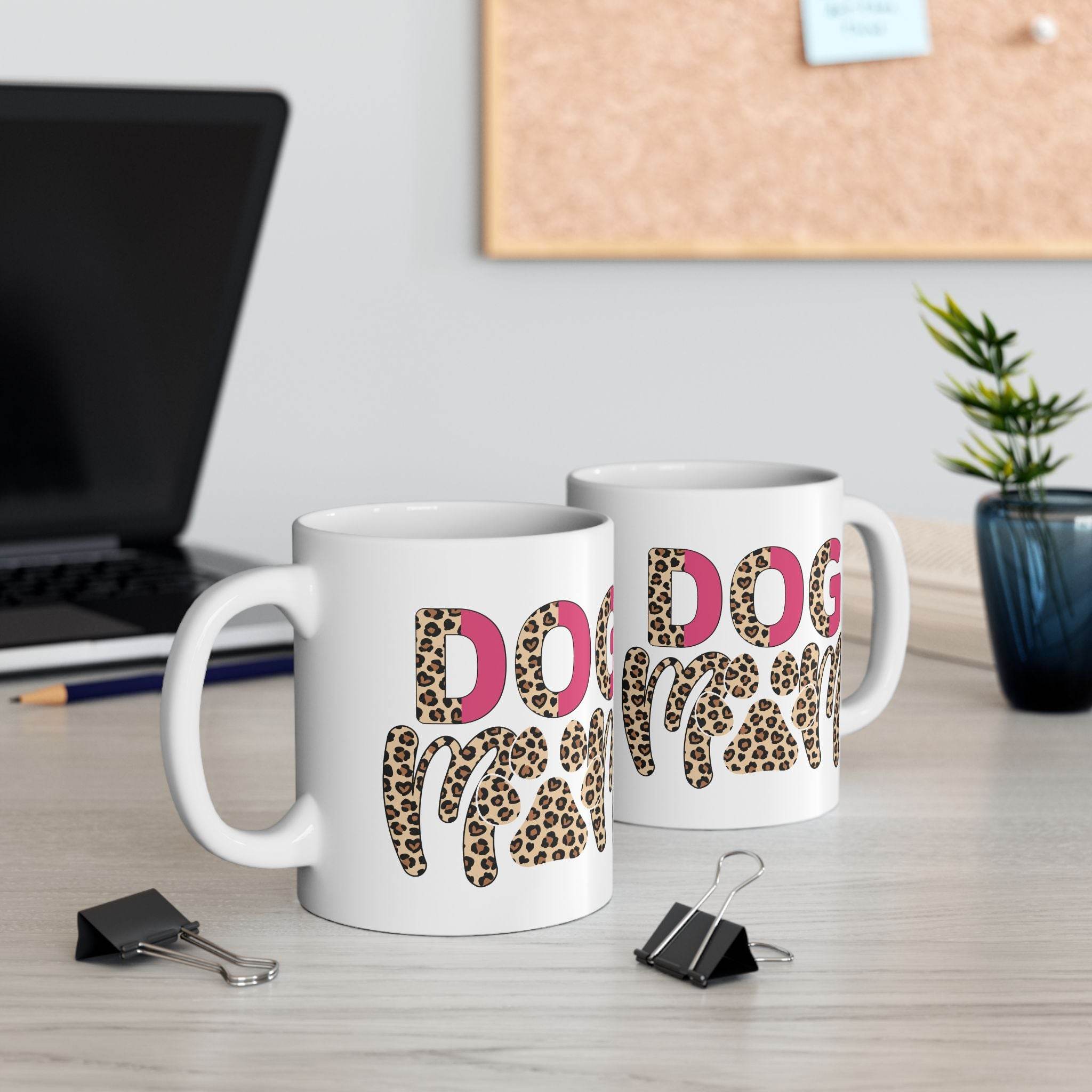 Printify eco friendly ceramic dog mom mug featuring two white mugs with leopard print DOG letters on office desk