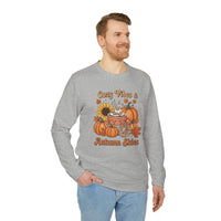 Man wearing grey long sleeve Printify sweatshirt with pumpkin sunflower fall graphic and text on eco-friendly autumn sweatshirt