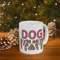 White eco friendly ceramic dog mom mug with leopard print DOG mom design on wooden table with pine cones and holiday lights