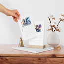 Printify eco-friendly 2025 desk calendar with dragon artwork and wooden stand on wooden table
