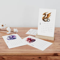 Printify eco-friendly 2025 desk calendar with dragon artwork on wooden stand and loose calendar pages on wood surface