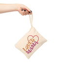 Printify eco-friendly accessory pouch in beige with Loved Mama design held by hand