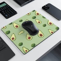 Eco-friendly avocado mouse pad by Printify with green background and avocado pattern under black wireless mouse