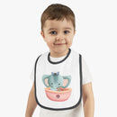 Toddler wearing Printify eco-friendly baby bib with cute elephant sailor design and black trim