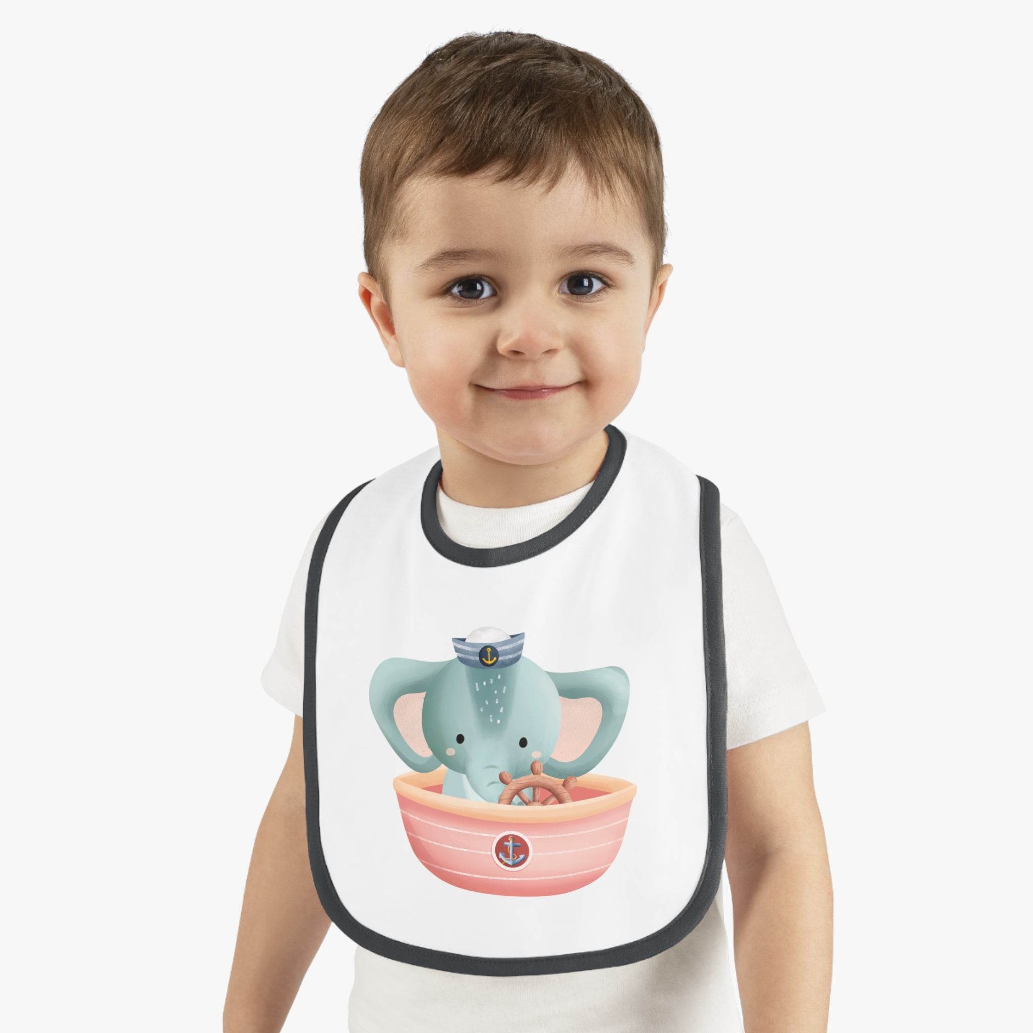 Toddler wearing Printify eco-friendly baby bib with cute elephant sailor design and black trim