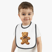 Child wearing Printify eco-friendly baby bib with teddy bear cookie design and black trim