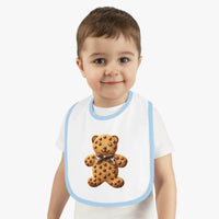 Toddler wearing a Printify eco-friendly baby bib with a teddy bear cookie design and light blue trim