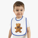 Toddler wearing Printify eco-friendly baby bib with teddy bear cookie design and blue trim