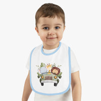 Toddler wearing eco-friendly baby bib with blue trim and cute safari animal print by Printify