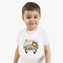 Toddler wearing a Printify eco-friendly baby bib with cute animal safari design and pink trim
