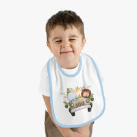 Printify eco-friendly baby bib with blue trim and cute safari animal design worn by smiling toddler