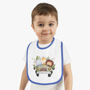 Toddler wearing an eco-friendly baby bib with blue trim and a safari animal car design
