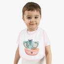 Toddler wearing Printify eco-friendly baby bib with pink trim and cute elephant nautical design