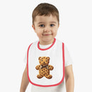 Toddler wearing Printify eco-friendly baby bib with red trim and teddy bear cookie design